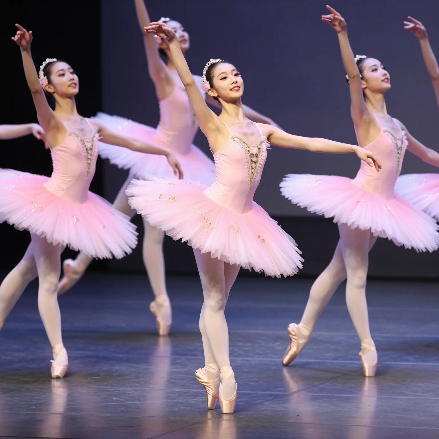 Ballerinas in pink tutus performing on stage